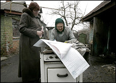 A Ukrainian woman votes in Muzychi, southwest of Kiev, in parliamentary elections seen as a verdict on the leaders of the 2004 Orange Revolution.